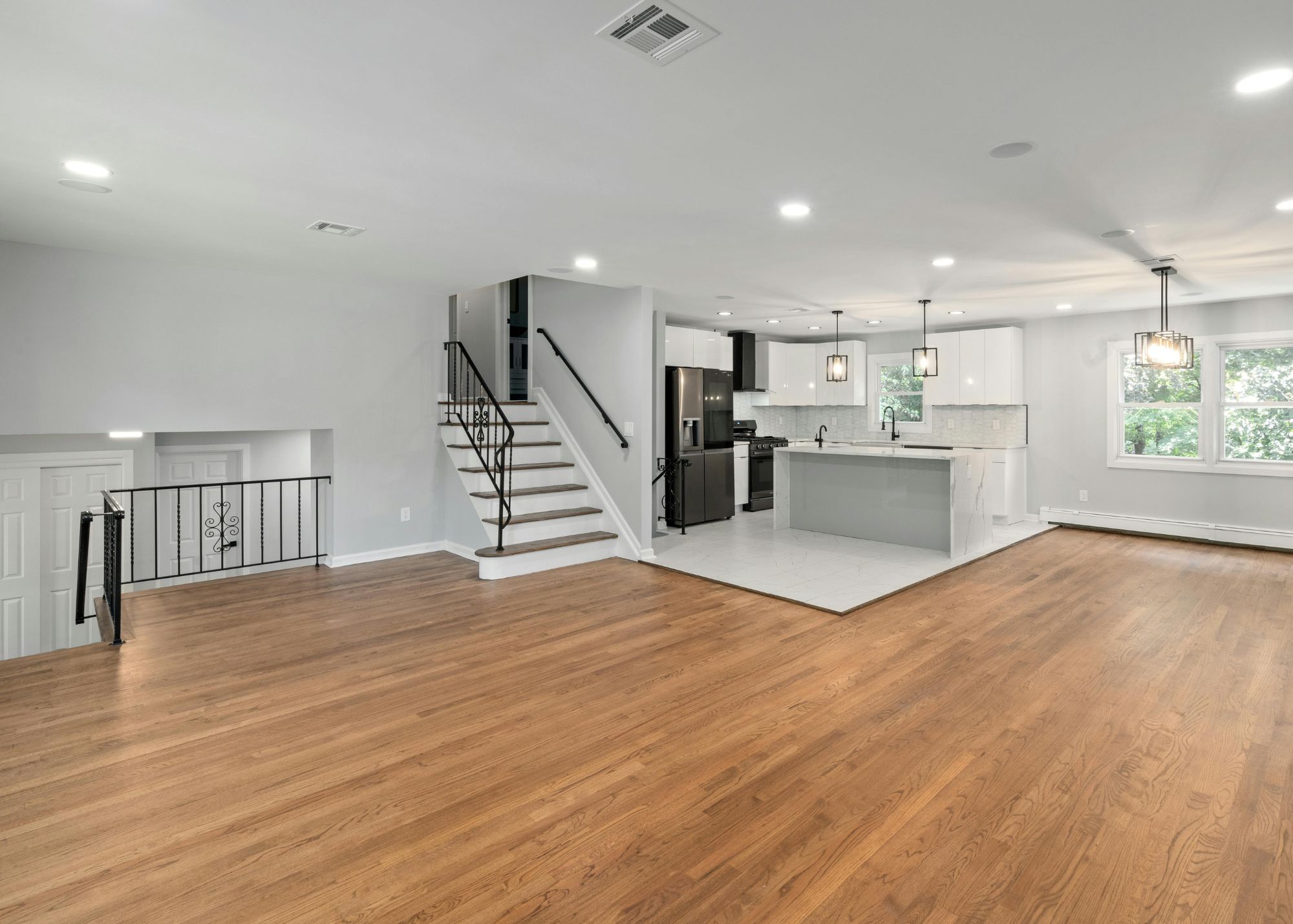 Refinished hardwood flooring in an open-concept living room
