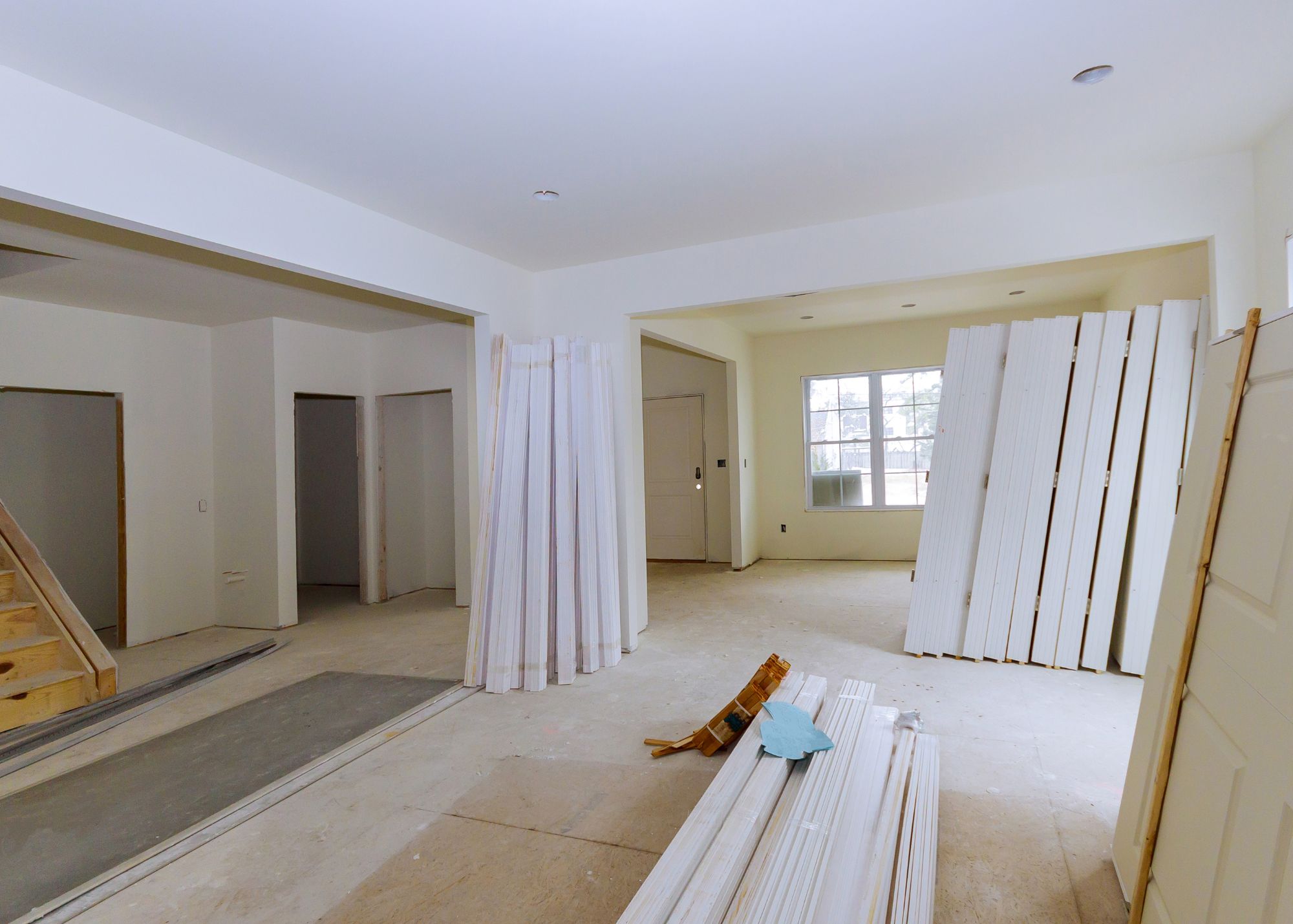 Interior of a home during a full renovation with fresh drywall and trim work