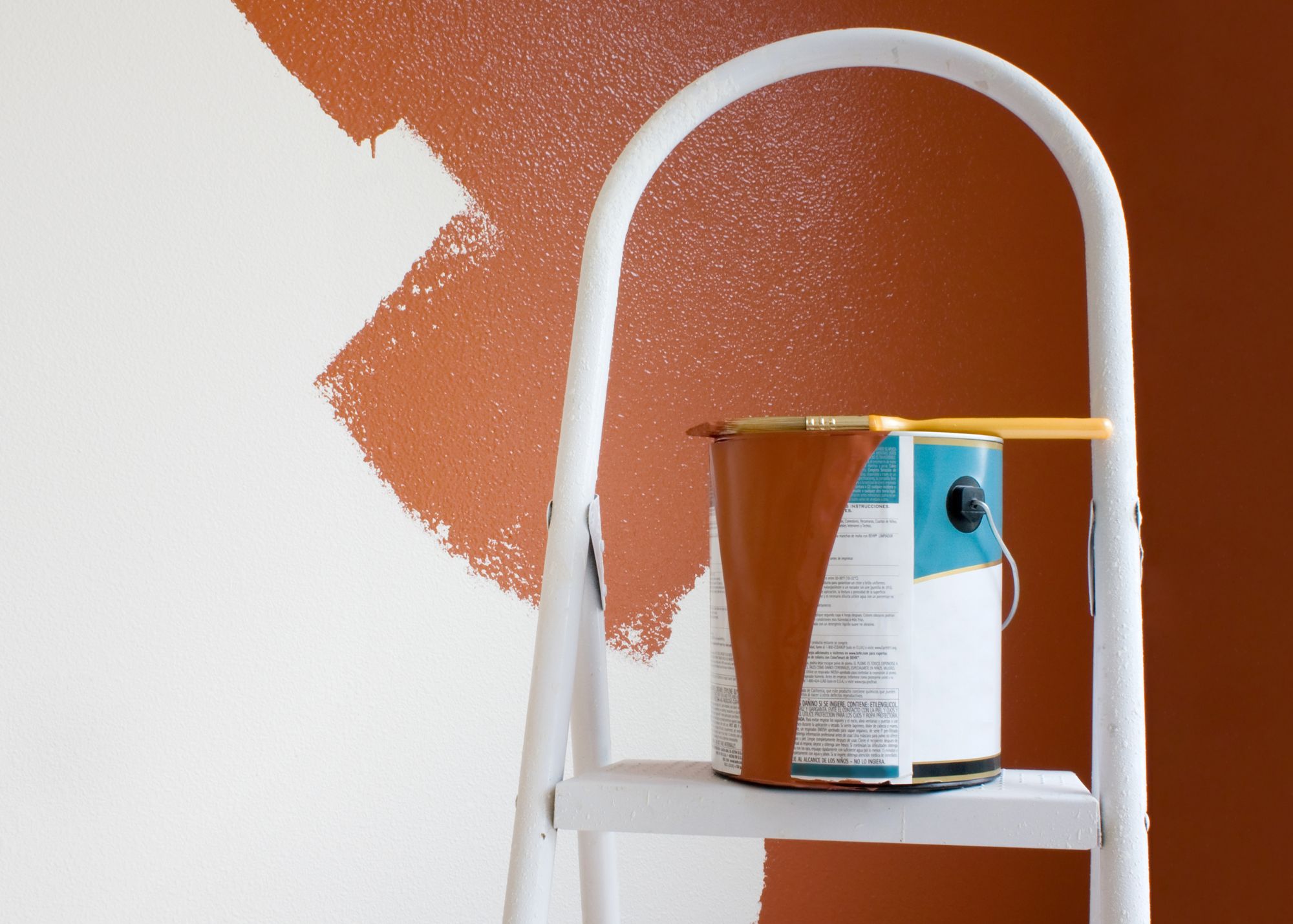 Fresh interior paint in progress with paint can and ladder
