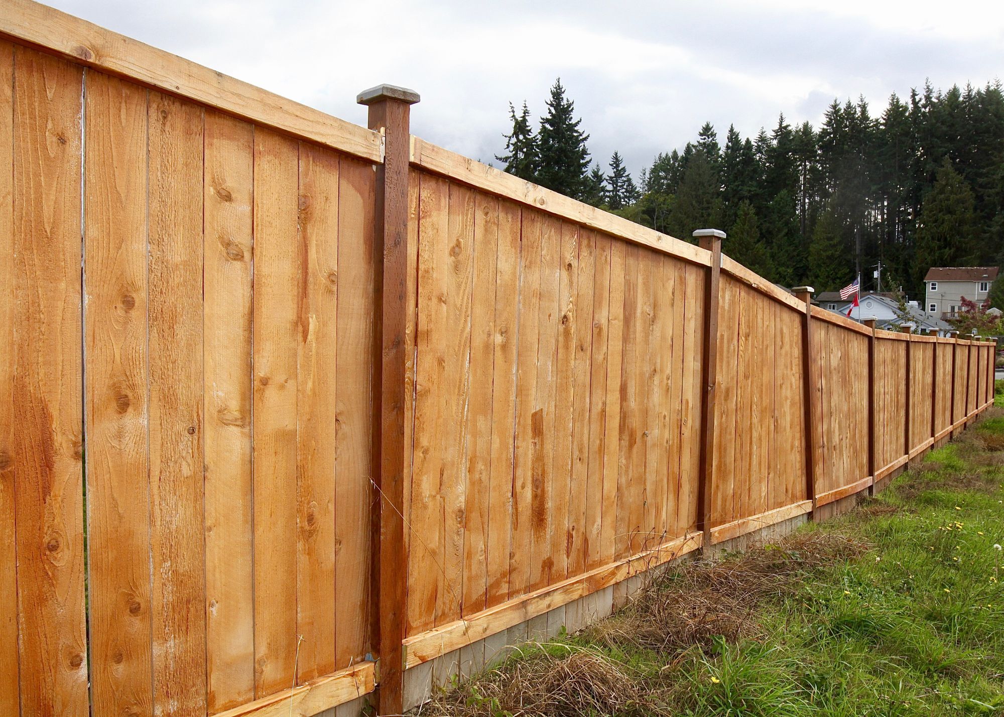 New wood privacy fence along a residential property line